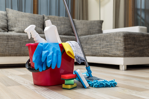 Cleaning service. Bucket with sponges, chemicals bottles and mopping stick. Rubber gloves and towel. Household equipment.