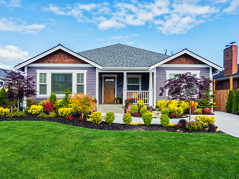 Photo of a modern custom single-level suburban home on a sunny summer day