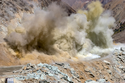 dynamite blasting in road construction at Tajikistan Mountains